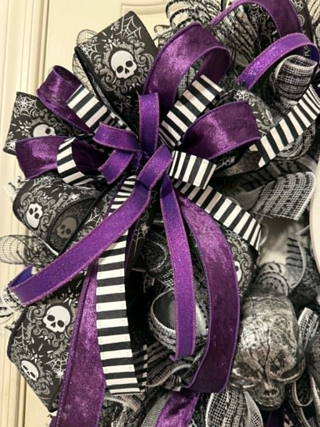 Purple and black striped ribbon bow detail