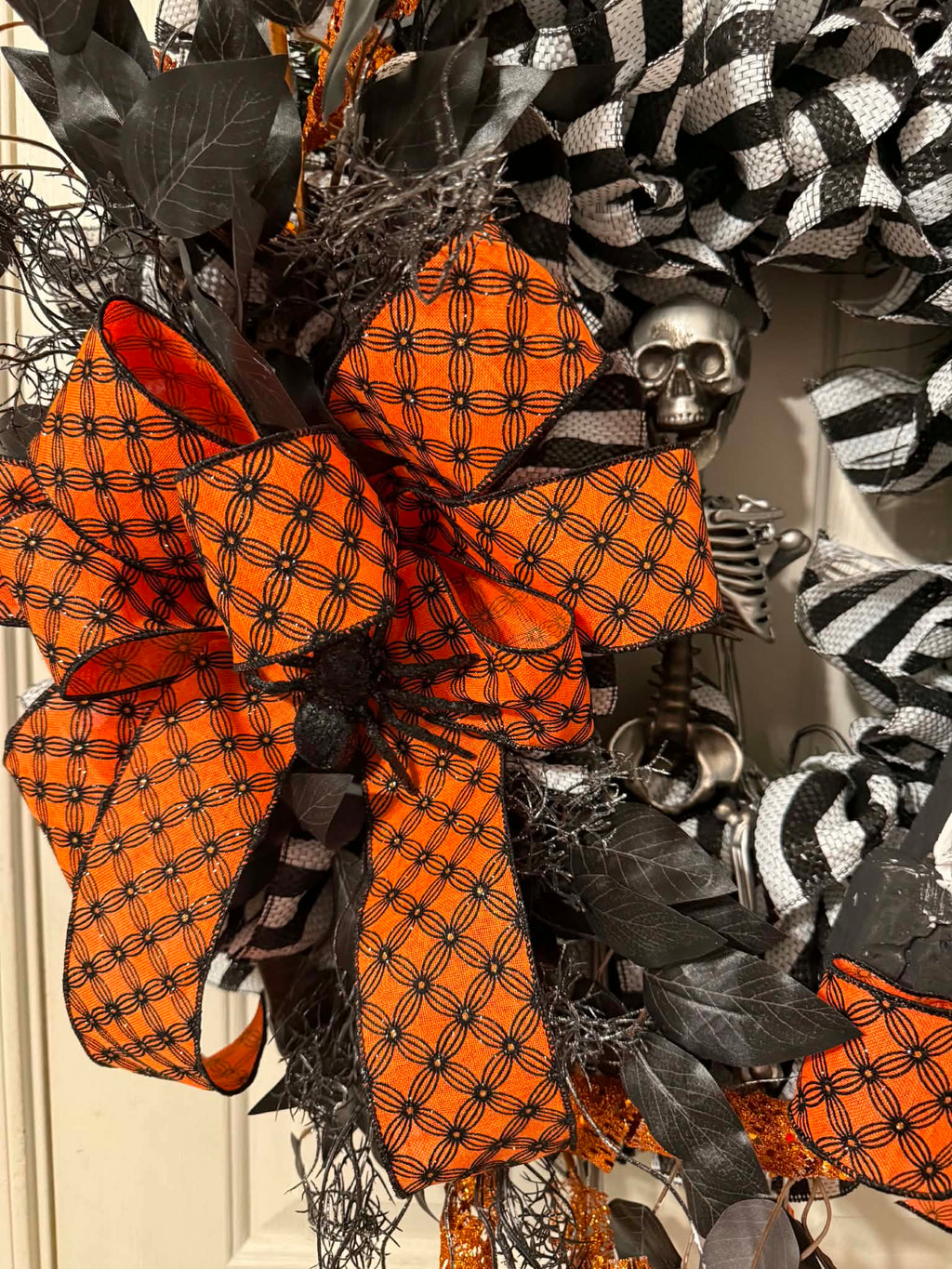 Orange spider-print bow detail close up