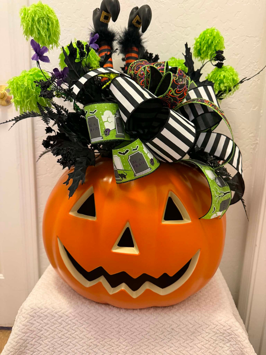 Halloween witch legs pumpkin centerpiece front view