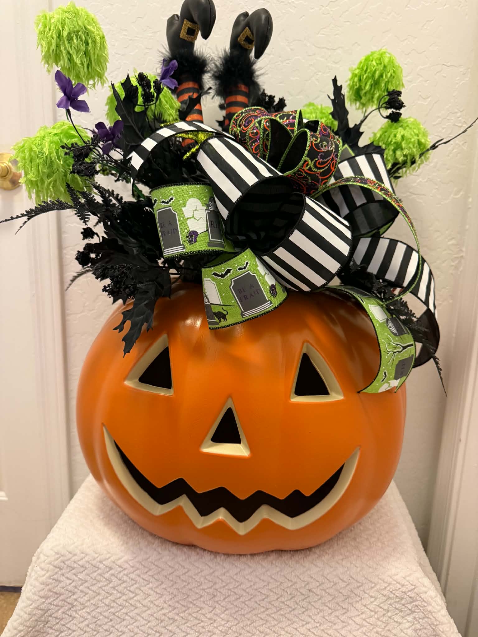 Halloween witch legs pumpkin centerpiece front view