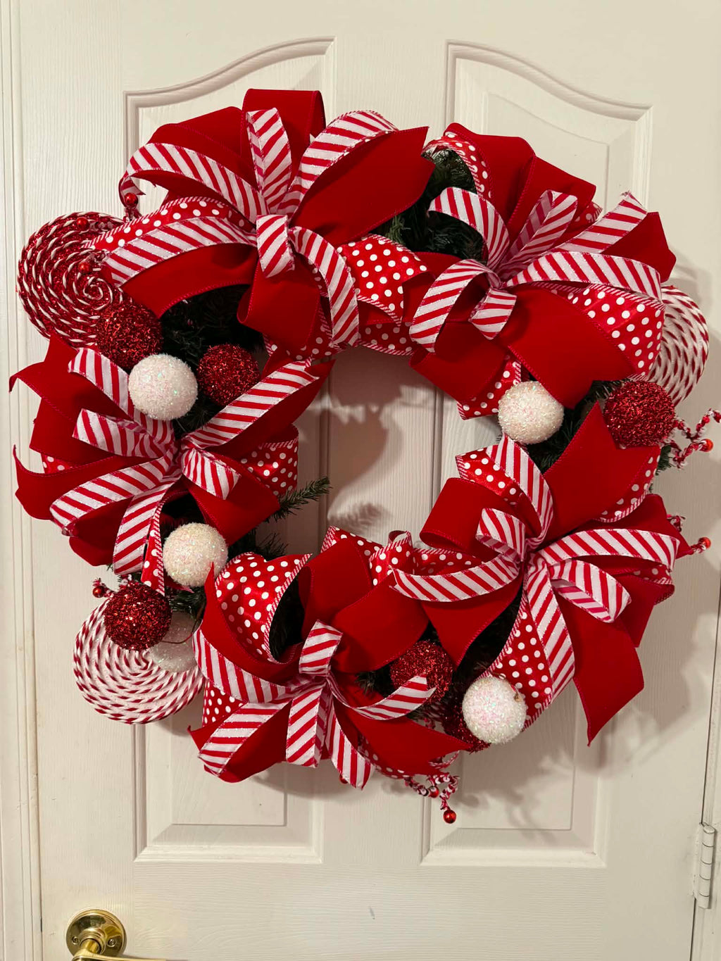 Candy Cane Christmas Wreath on white door - full view