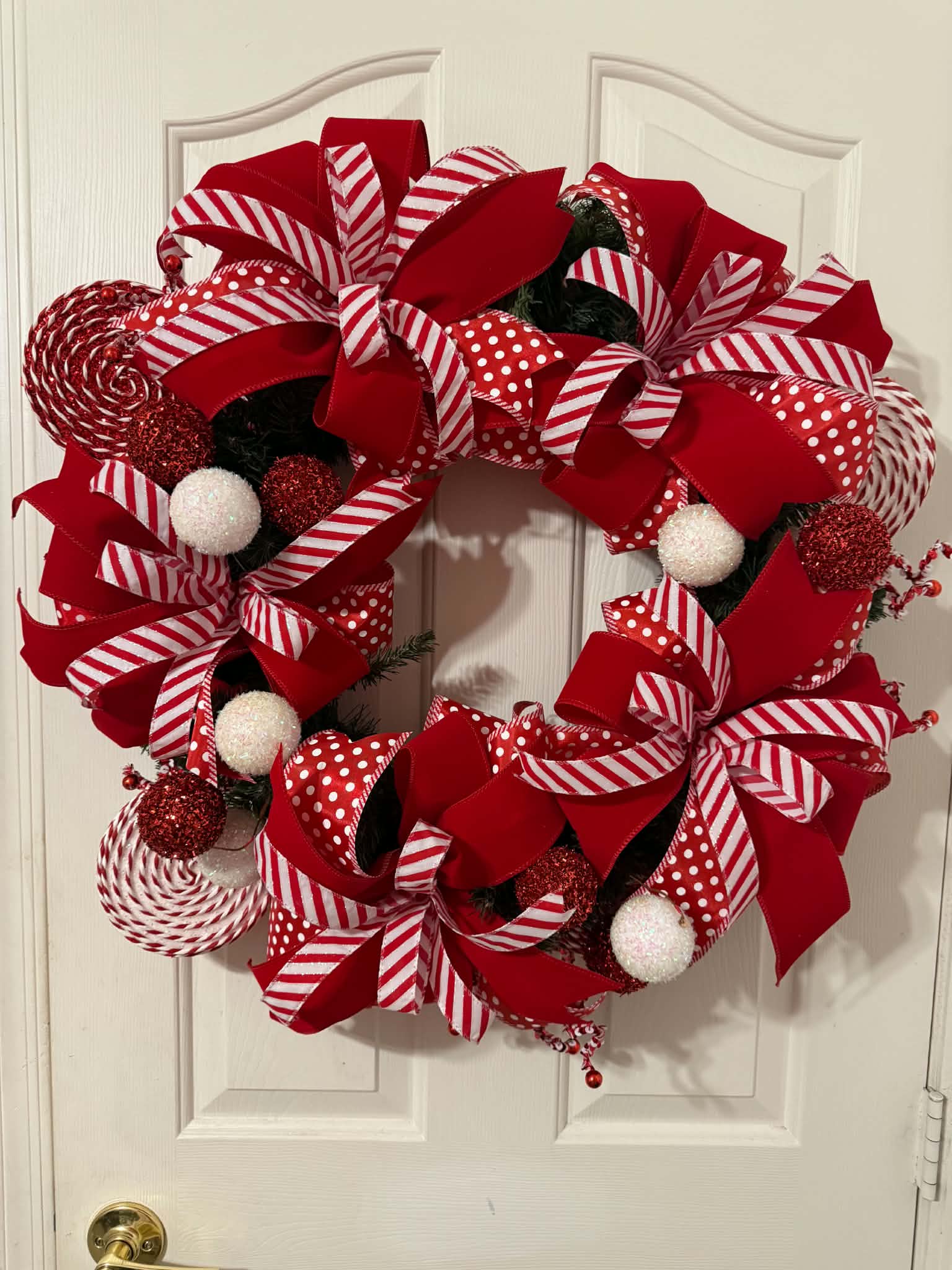 Candy Cane Christmas Wreath on white door - full view