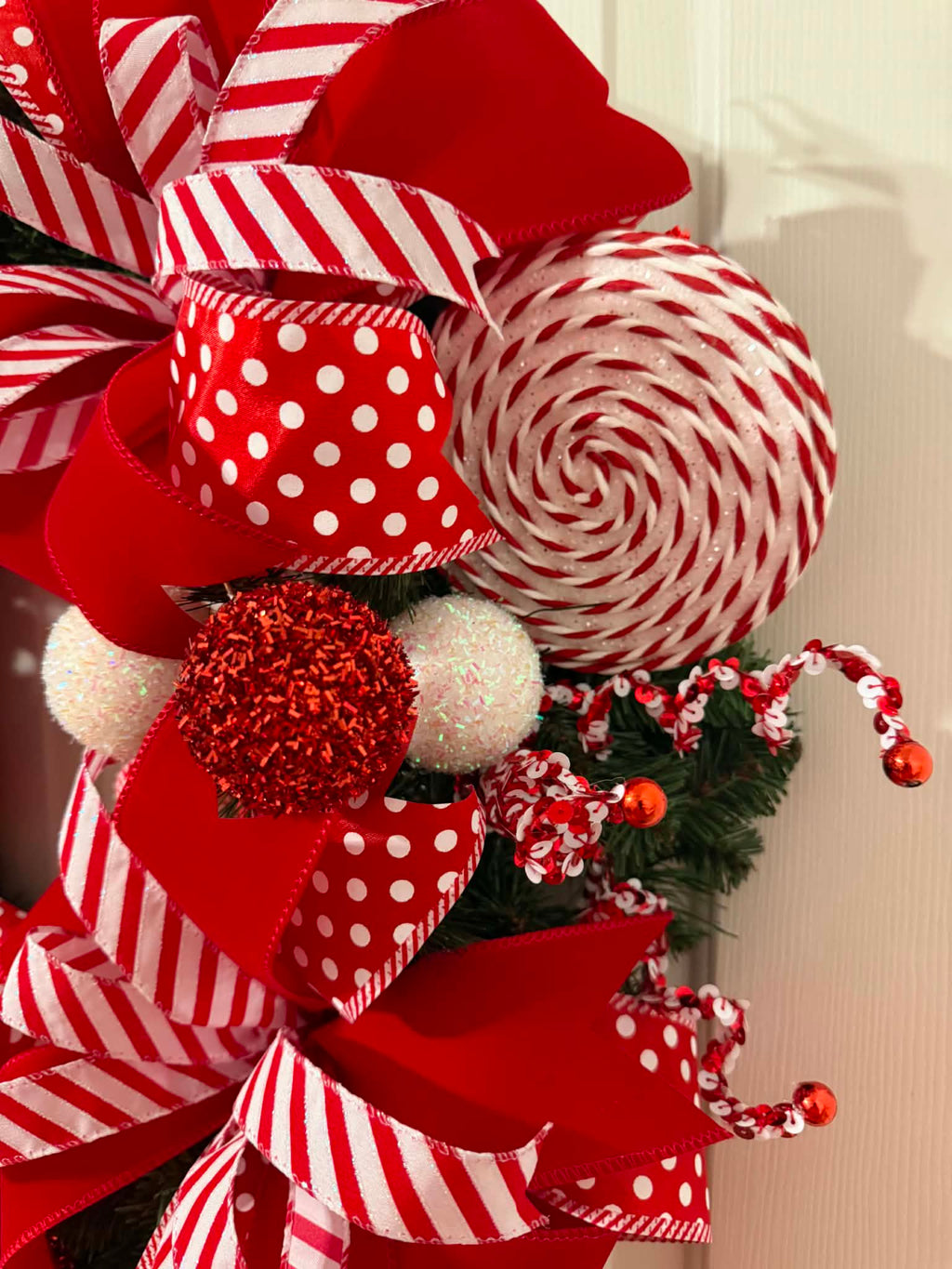 Candy Cane Christmas Wreath close-up - peppermint lollipop and ribbon detail