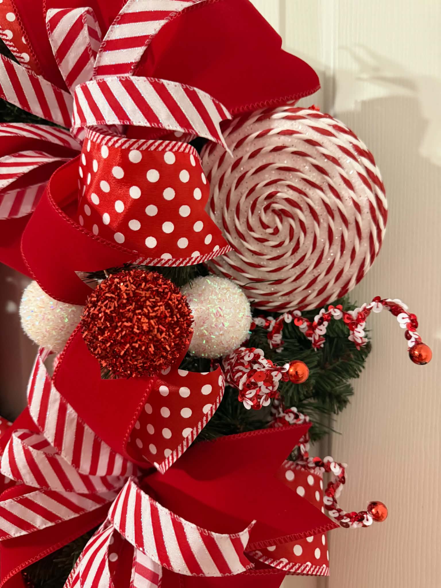 Candy Cane Christmas Wreath close-up - peppermint lollipop and ribbon detail
